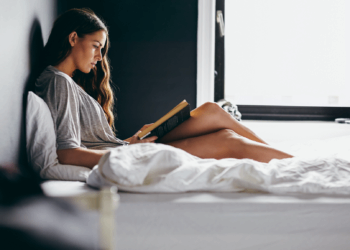 girl reading in bed